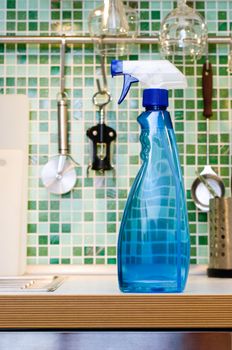 Blue cleaning spray bottle on kitchen table