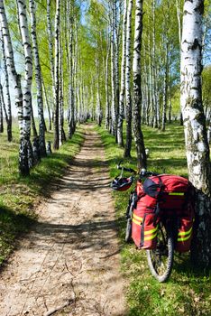 Loaded touring bicycle and helmet on rest break