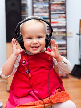 Cute baby girl listening to a music