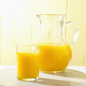 Glass and Pitcher of Orange Juice