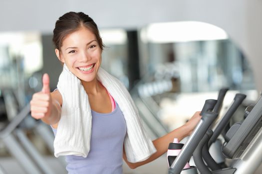 Happy fitness woman thumbs up in gym during exercise training on moonwalker treadmill.