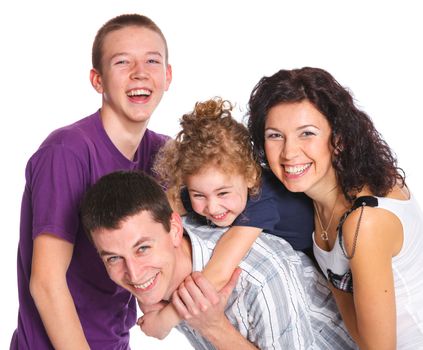 Portrait of beautiful smiling happy family of four - isolated over a white background