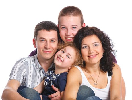 Portrait of beautiful smiling happy family of four - isolated over a white background