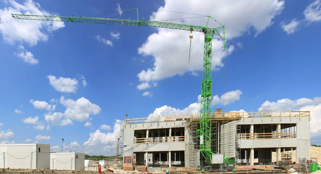 building construction site with a crane on blue sky background
