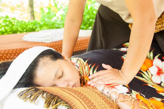 Back Massage Spa with Hand in tropical garden for wellness and healthy background