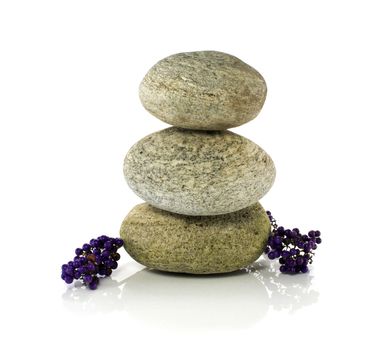 stones in balance with purple berries