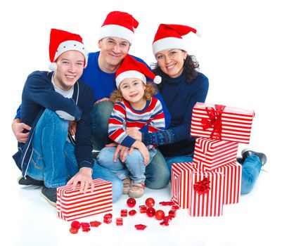 Portrait of friendly family in Santa's hat with gift box, isolated on white