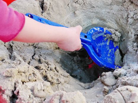 The Child game of sandbox. In frame only hands.