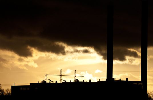 Industrial plant spewing out fumes from three chimneys 
