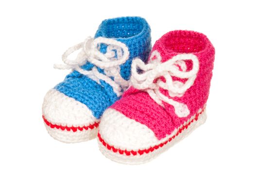 Handmade blue and pink baby booties isolated on white background