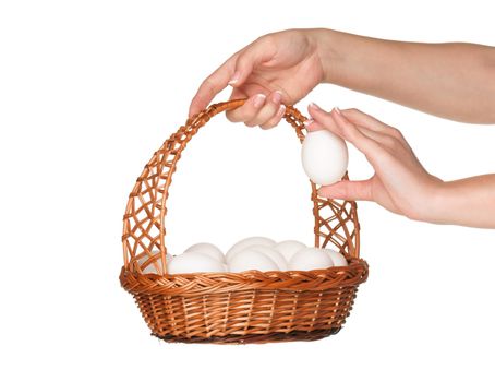 Basket with eggs in woman hand isolated on white background