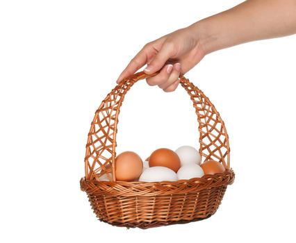 Basket with eggs in woman hand isolated on white background