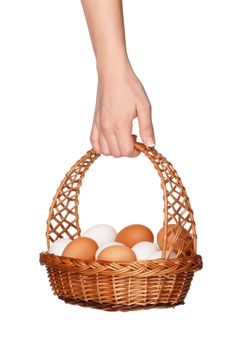 Basket with eggs in woman hand isolated on white background