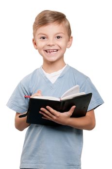 Portrait of a funny little boy holding a books over white background