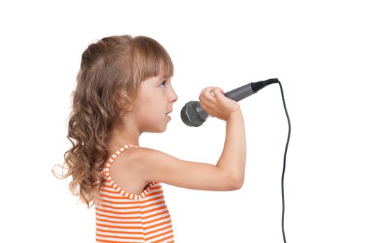 Funny little girl singing with a microphone isolated on white background