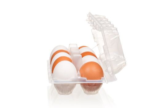 Brown and white eggs in the plastic box over white background