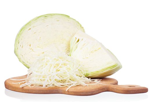 Fresh cabbage shredded on wooden chopping board on white background