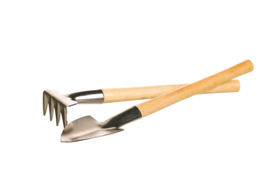 Garden rake and spade with a wooden handle isolated over a white background