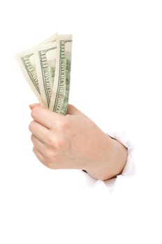 Woman hand with dollars through a hole in paper isolated on white background