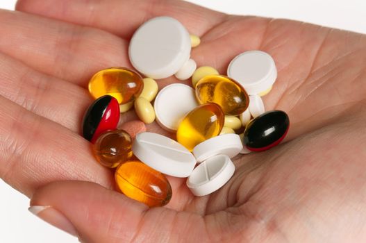 Close-up of woman hand with colorful pills