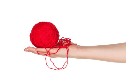 Woman hand with red ball of yarn for knitting isolated on white background