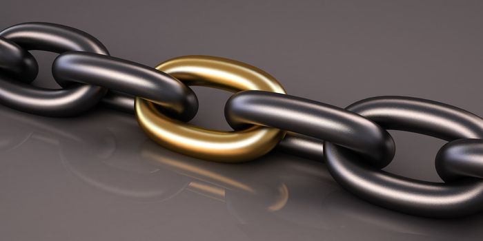 Metal chain, close-up on gray glossy background. One link in a chain of gold
