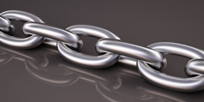 Metal chain, close-up on gray glossy background