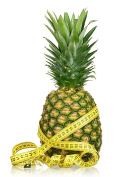 Fresh ripe pineapple with a measure tape isolated on white background