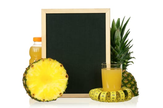 Fresh pineapple juice and ripe pineapple with a blackboard and measure tape over white background