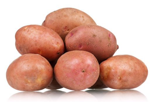 Heap of large raw potatoes on a white background