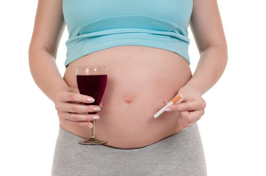 Pregnant belly with wine and cigarettes - isolated over a white background. Third trimester.