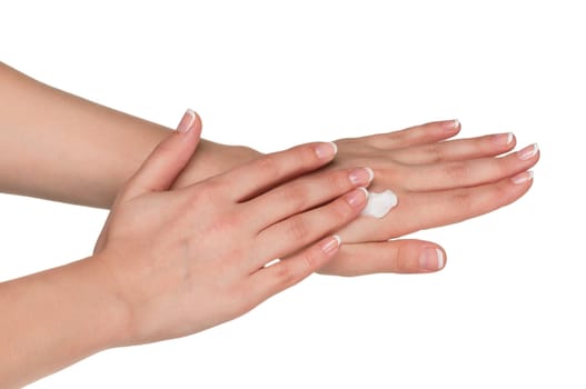 Woman hands with french manicure applying hand cream isolated on white background