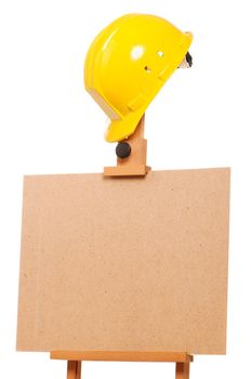 Wooden easel with hard hat isolated on white background