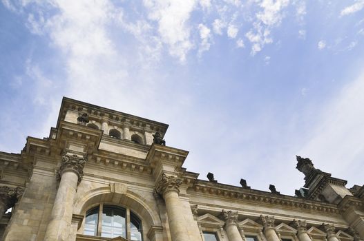 side view to Berlin Reichstag with cloudy sky background