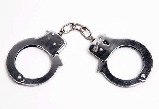 Metal handcuffs on white