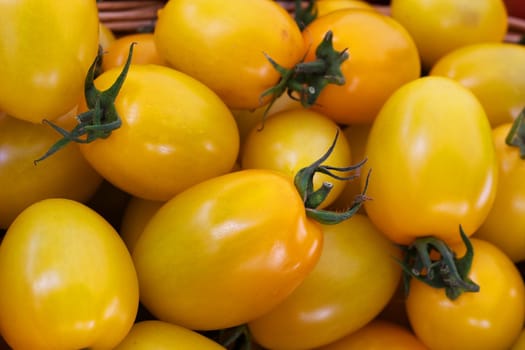 Pile of ripe Yellow PlumTomatoes at the farmers market