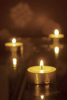 three candles light, shallow DOF; focus on front candle