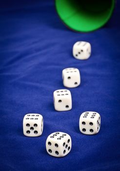 Six dice with number six facing up on blue board