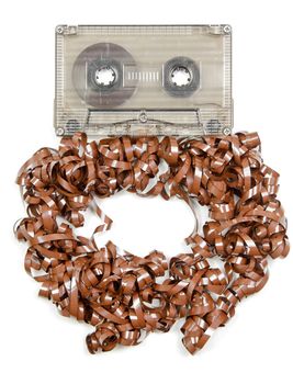 Vintage transparent Compact Cassette with pulled out tape on white background