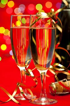 Two glasses of champagne with blured lights in background, very shallow DOF