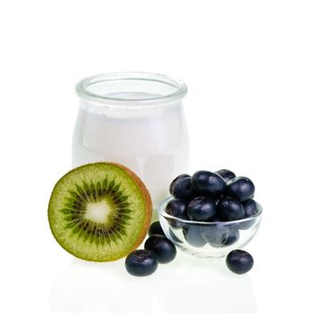 Old-fashioned yogurt jar and fruits on white background