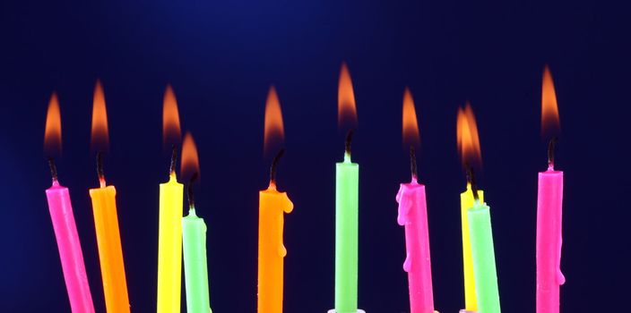Some lit birthday candles close up 