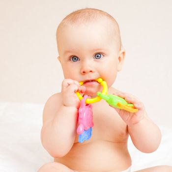 Little baby girl with teething toy