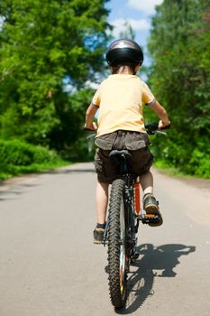 Young boy riding bicycle, shallow dof
