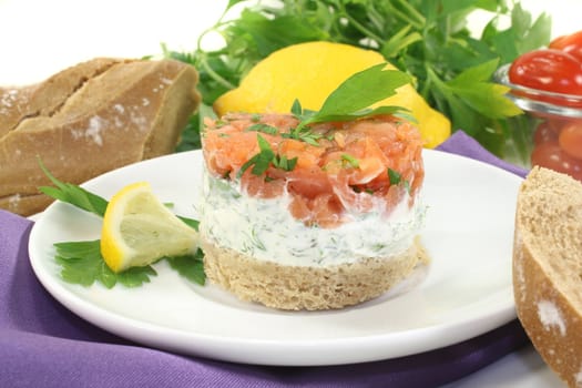 a slice of bread with herb cream and salmon tartare