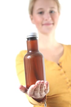 girl holding a brown plain bottle