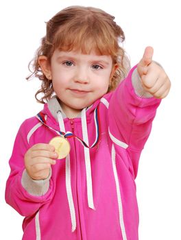 Little girl with golden medal and thumb up studio shot