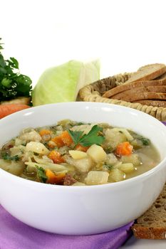 a bowl of cabbage soup and fresh parsley