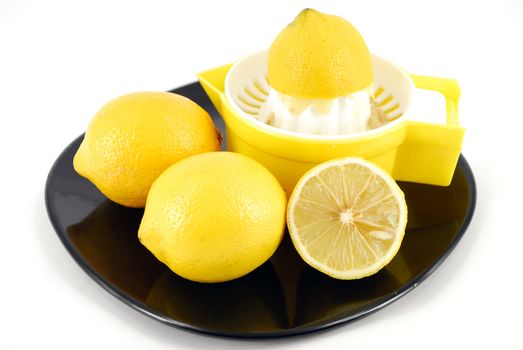 Lemon and strainer on black dish