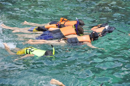 Active traveler diving snorkeling in beautiful clean ocean on summer vacation at Chang island, Thailand